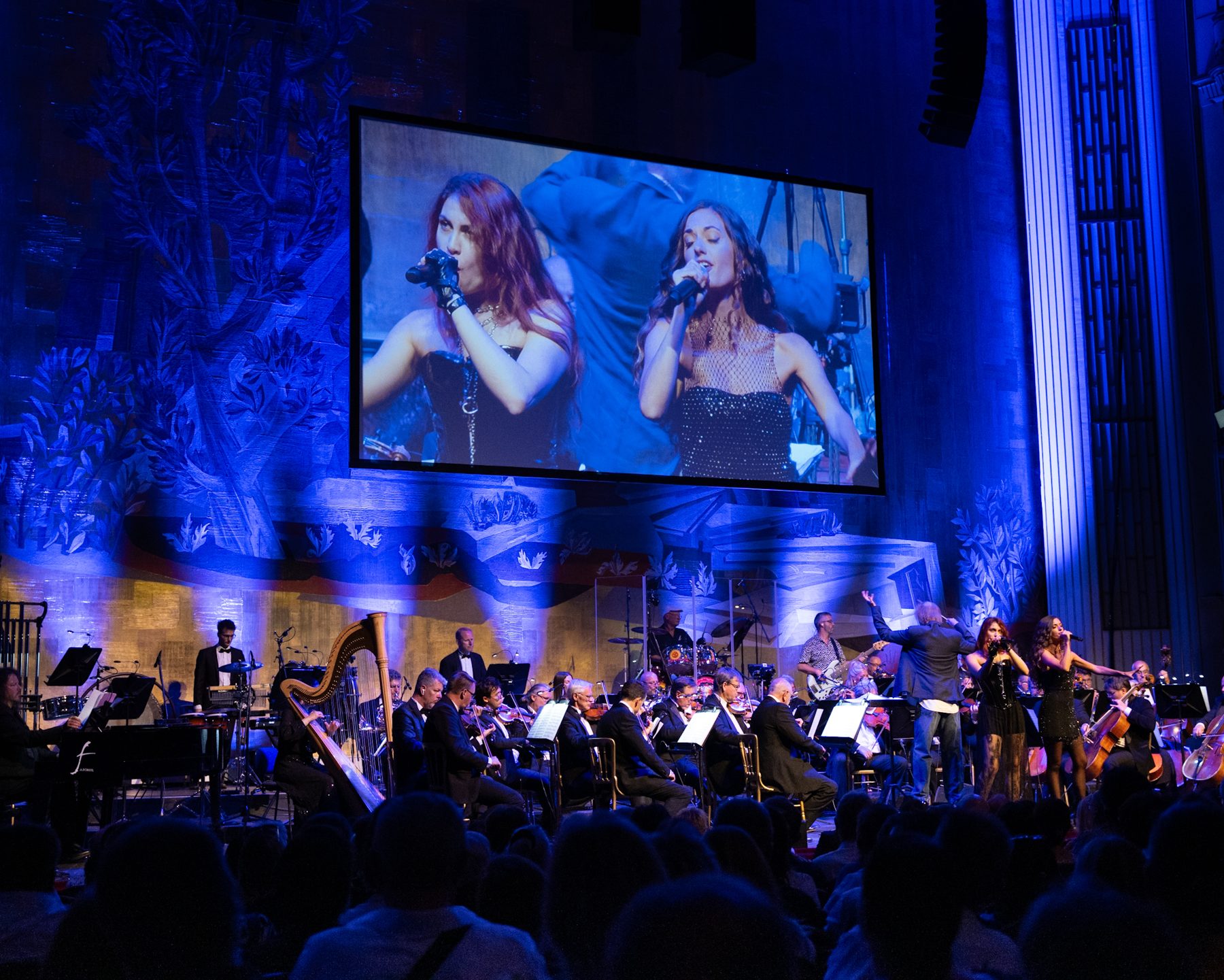 The full ensemble under blue light with a big screen