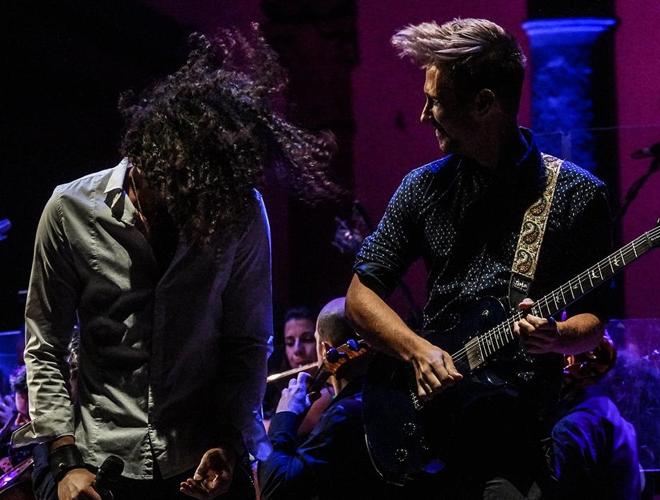 Guitarist and singer in front of the orchestra